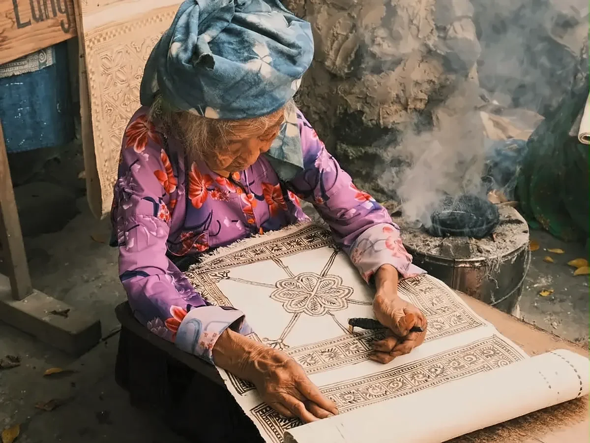 Local woman creating traditional textile art in Ha Giang