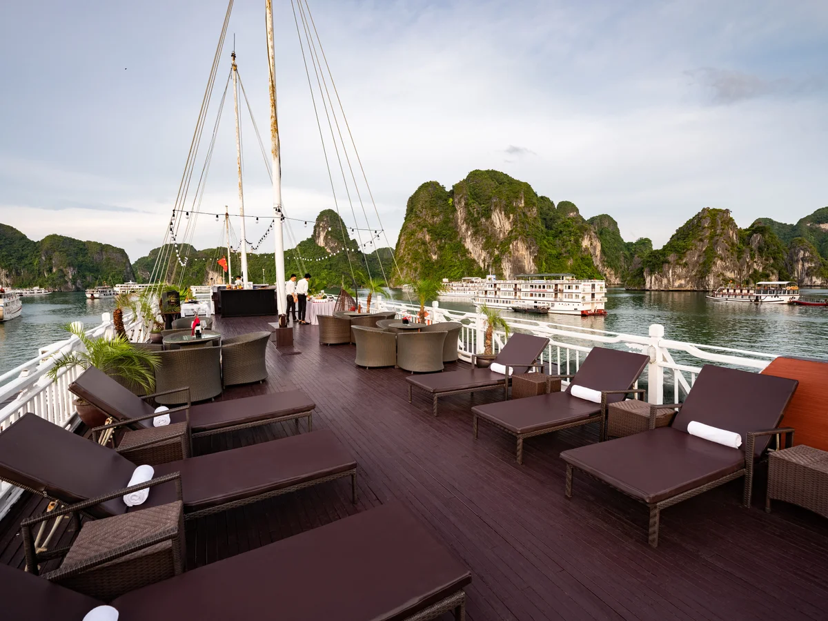 Sun beds on a cruise ship with water and small islands around