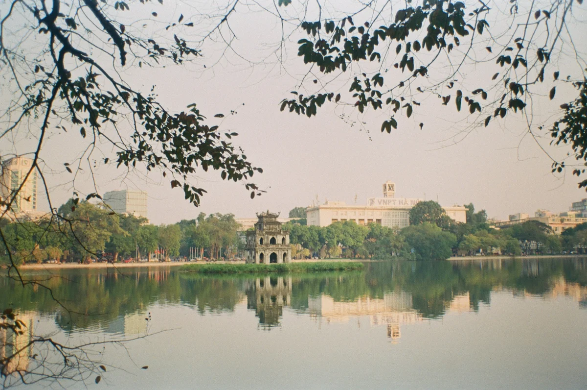 Pagoda on a lake with trees around and reflections in the water
