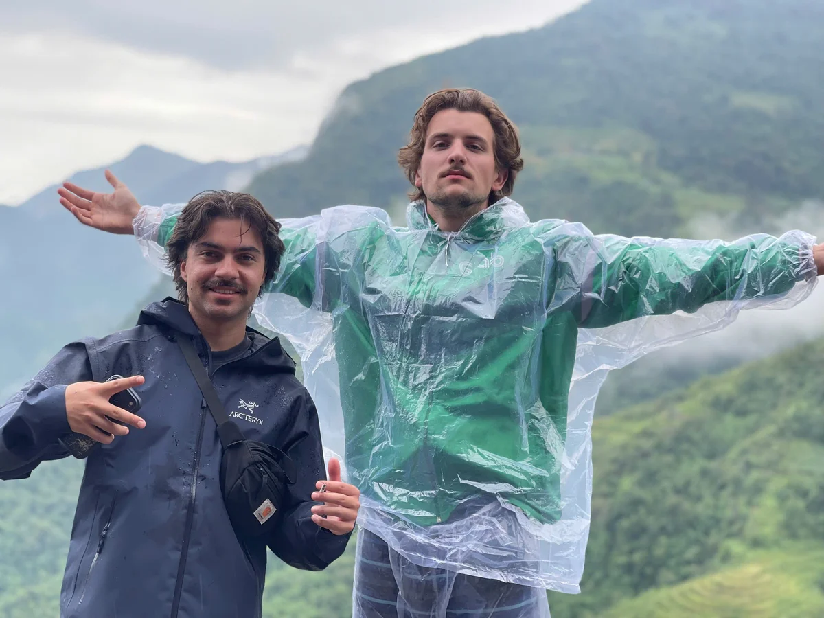 Two people pose with outstretched arms