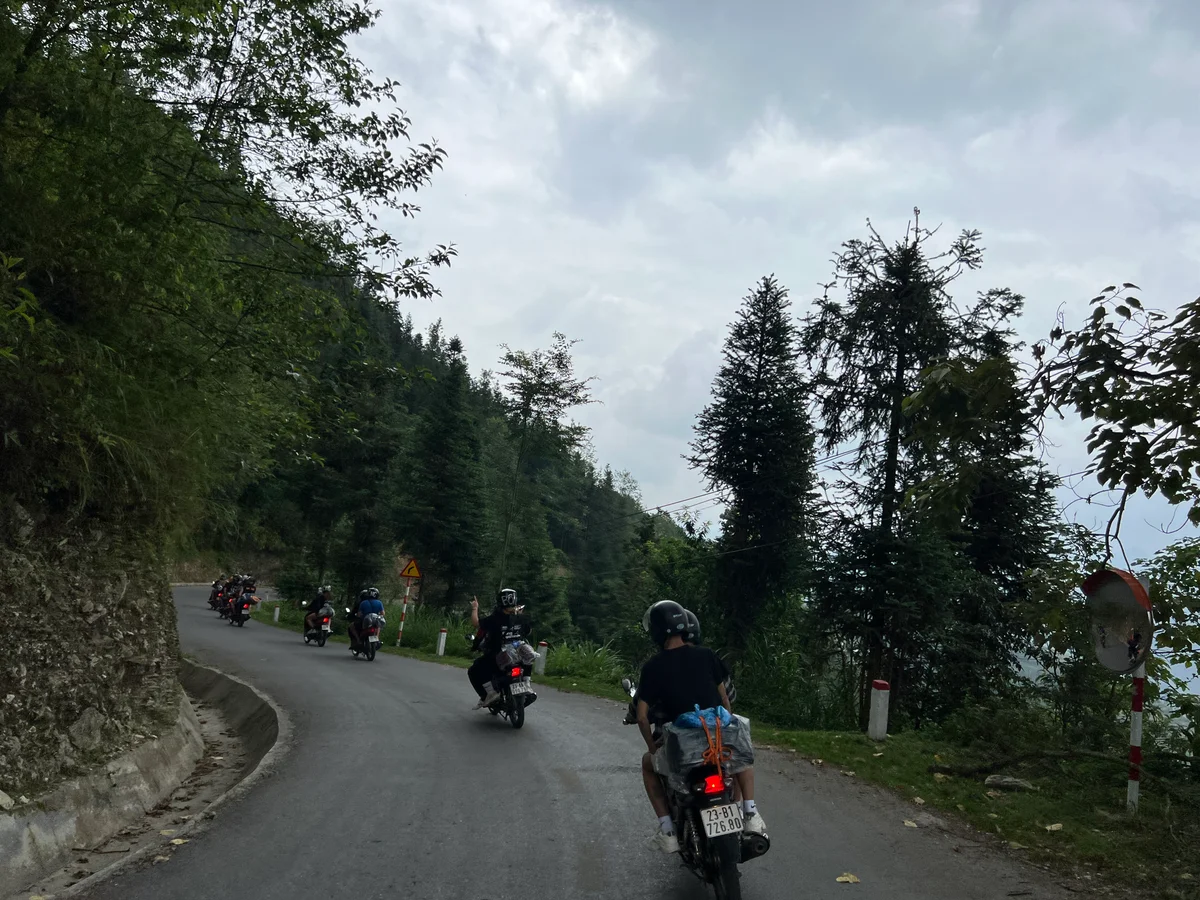 Motorbike group riding through the mountain roads of Ha Giang