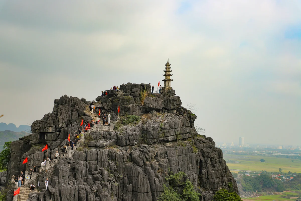 The top of a mountain with a temple and lots of steps up