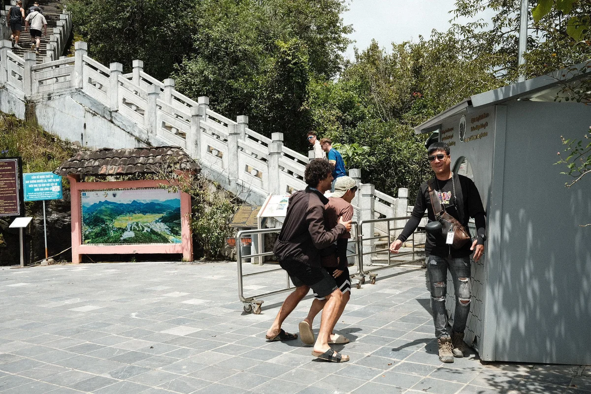 Guest and easy riders  playing at the bottom of the steps up to the Lung Cu Flagtower