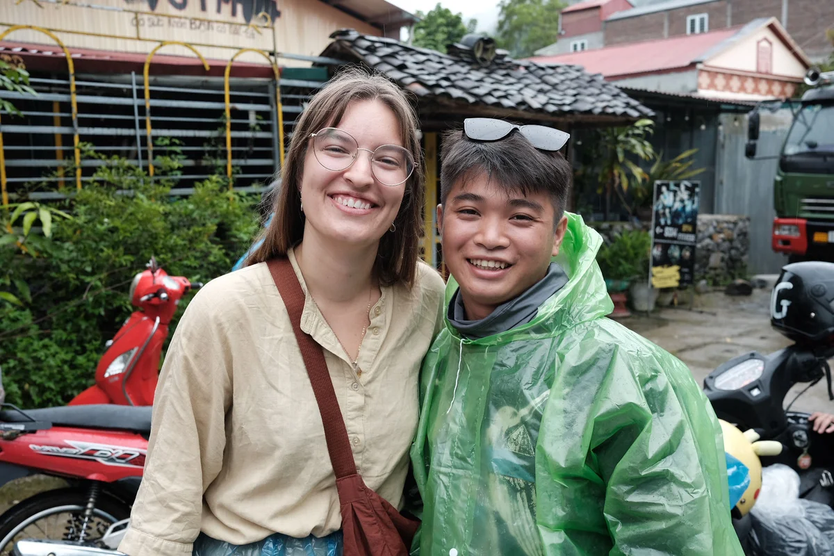 Two people posing in a village in North Vietnam