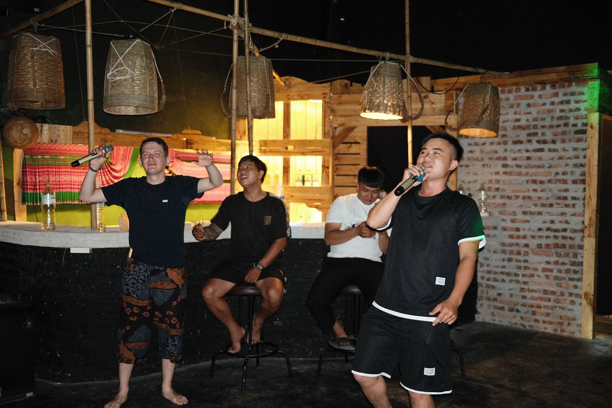 Guests and easy riders singing and dancing in a homestay 