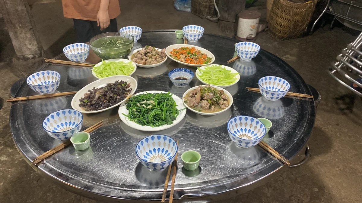 Family-style dinner with bowls and chopsticks in Sapa