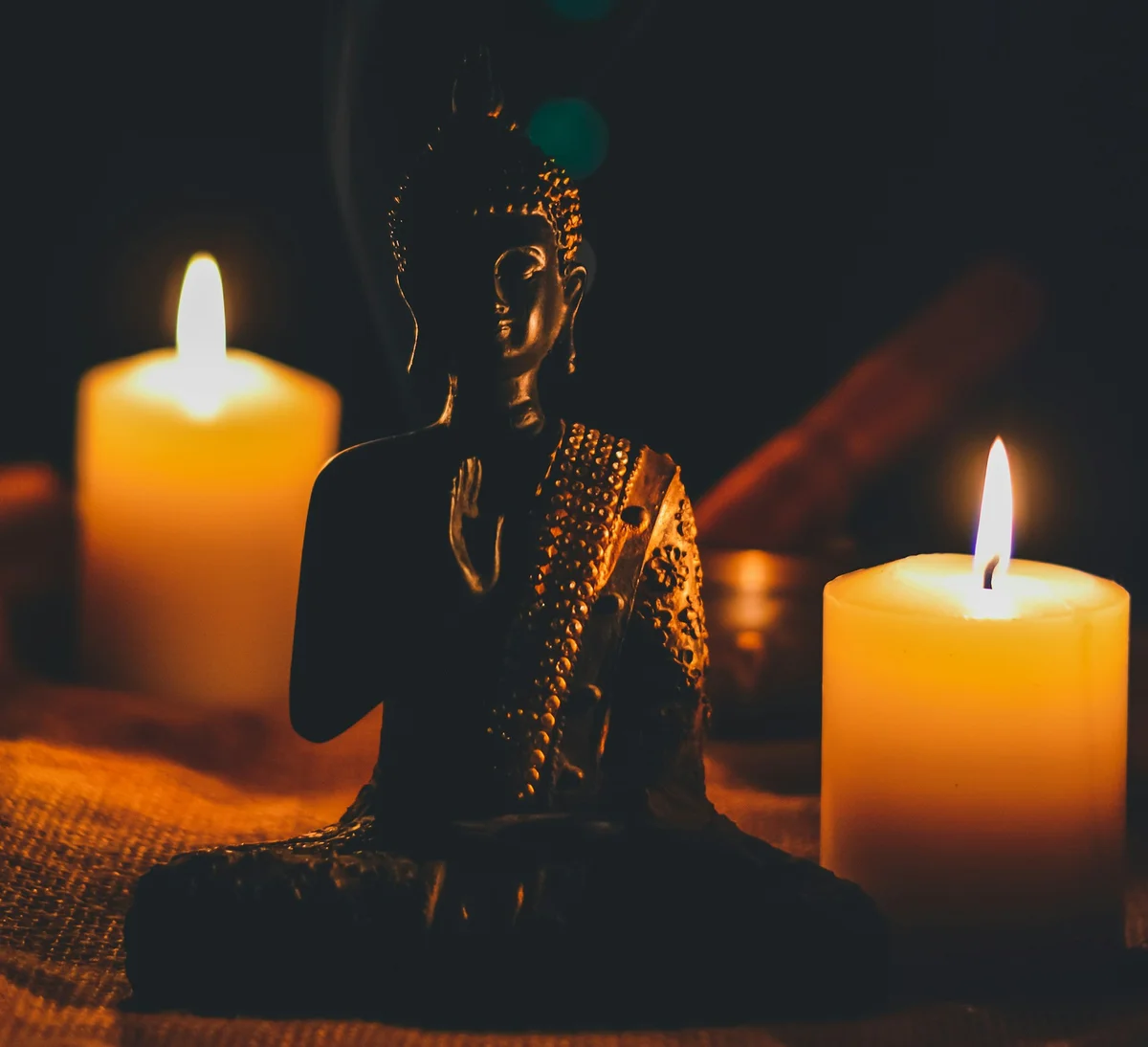 Buddha statue with two candles behind