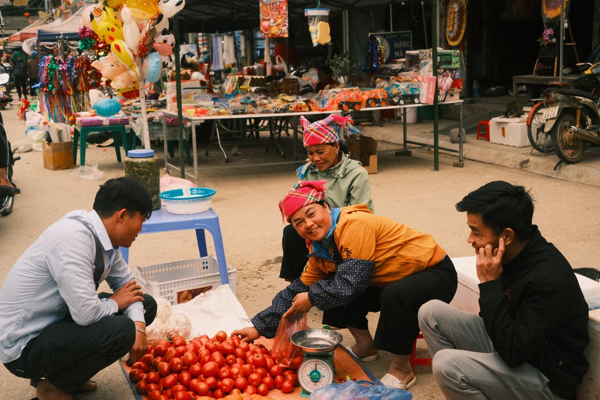 Bong Hostel Tour Leader buying produce at a market along the Ha Giang Loop