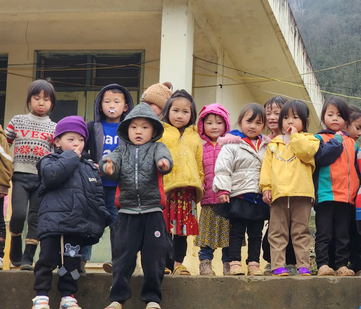 A group of children smile at the camera