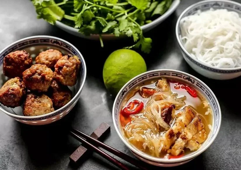 try local dishes like Bún Chả