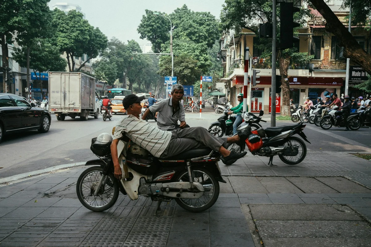 Two men chilling on their motorbikes in Vietnam