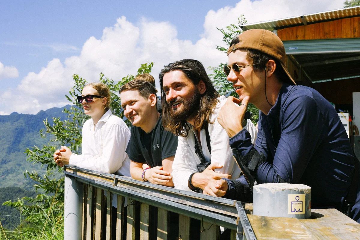 Guests relaxing in the sunshine looking out towards the mountains