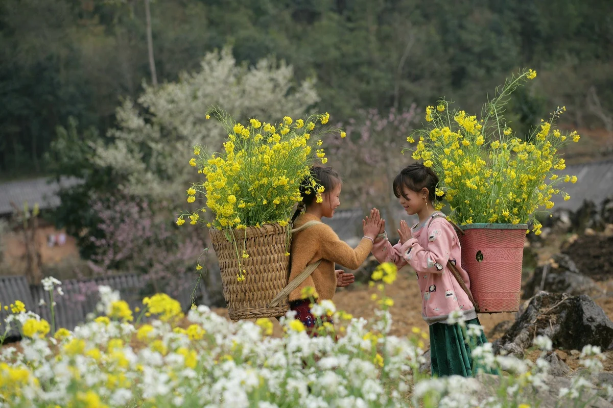 Girlss playing in the middle of flowers