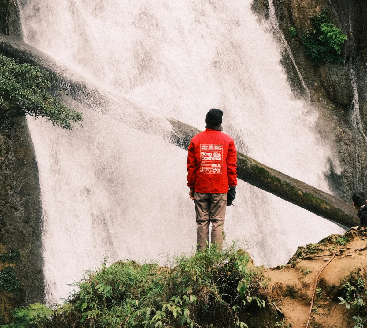 Bong Hostel tour leader looks up at a hidden waterfall