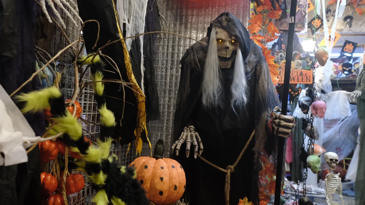Creepy Halloween costumes hang in the street