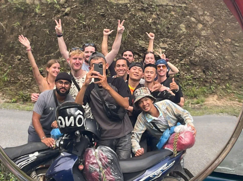 Group of Bong Hostel guests pose with their Ha Giang Loop Easy Riders