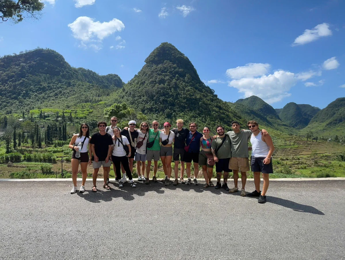 guests posing in front of the dramatic karsts on the ha giang province