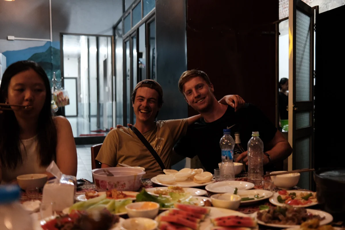 Two people pose for a photo in the middle of dinner