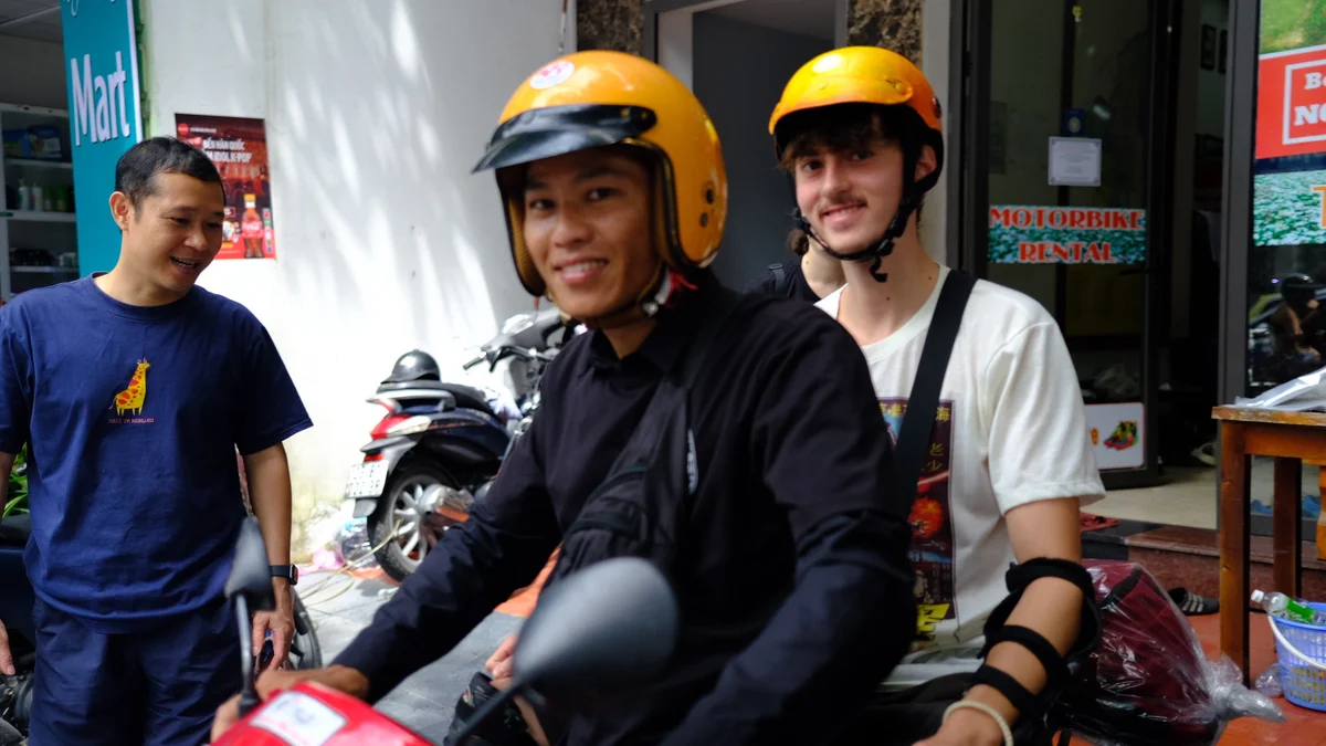 Two people on a motorbike smiling