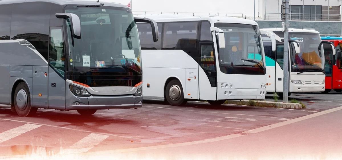 Several buses parked up at a bus station