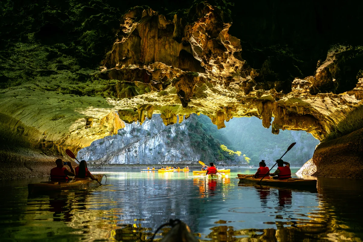 Kayakers paddling through caves