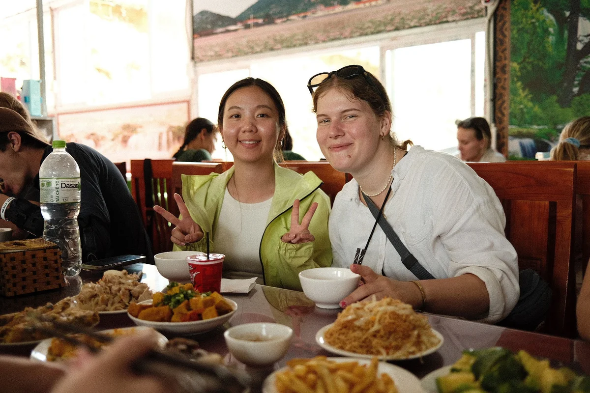 Two girls posing with their lunch