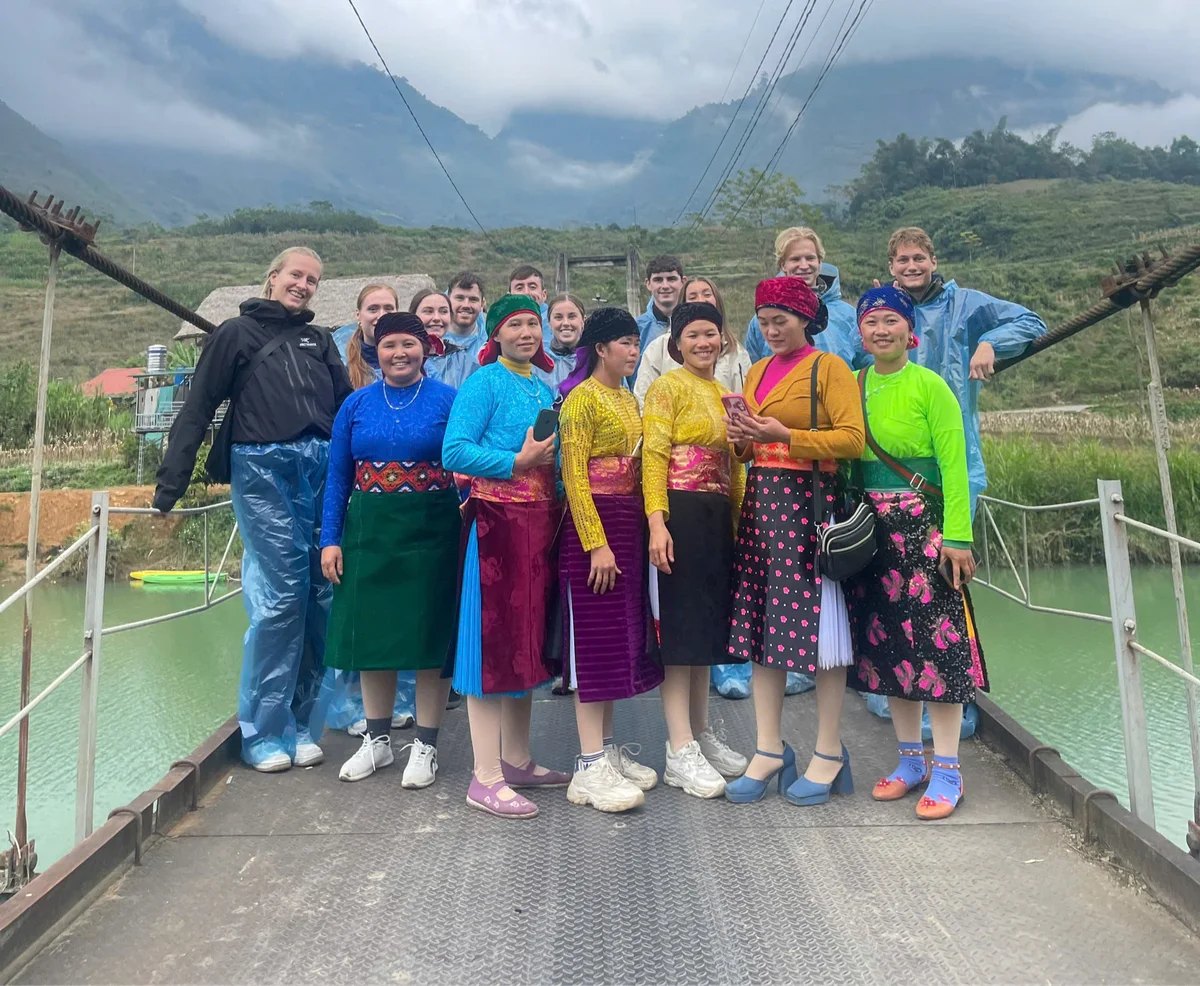 Bong Hostel Ha Giang Loop tour pose for a group picture with some local women