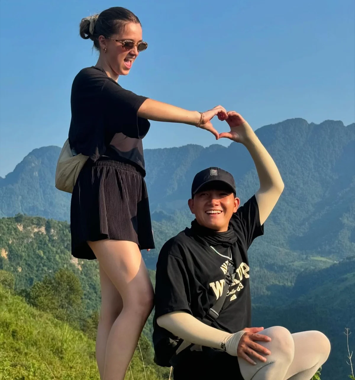 Happy guest and easy rider form a heart shaped gesture