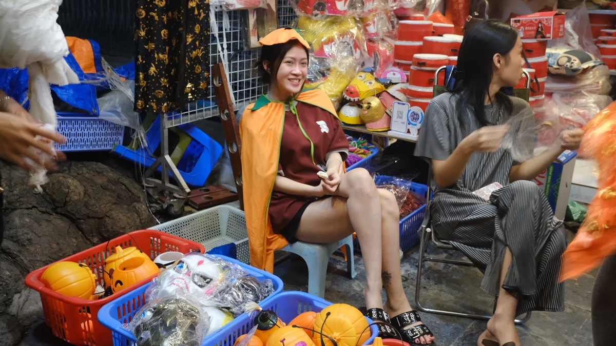 Woman dressed as a pumpkin smiles for the camera
