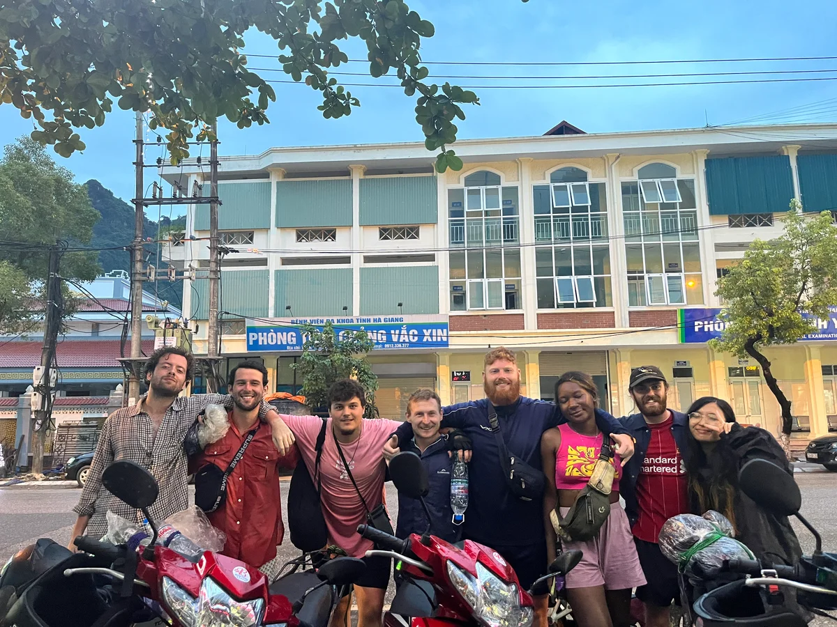 Group of guests smiling at the camera w3ith their arms over each other