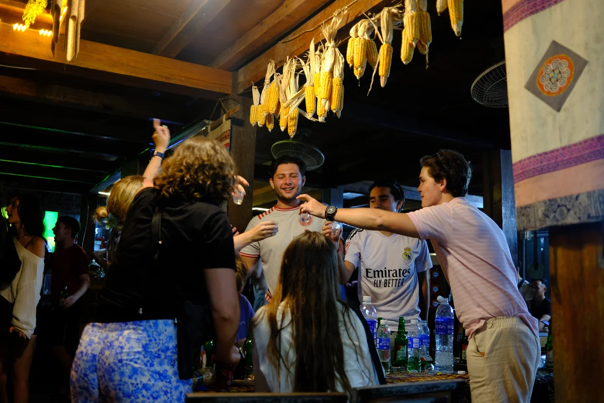 Bong Hostel guests cheers with shots of Happy Water