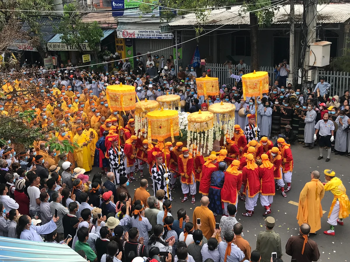 Street crowded with people watching a parade
