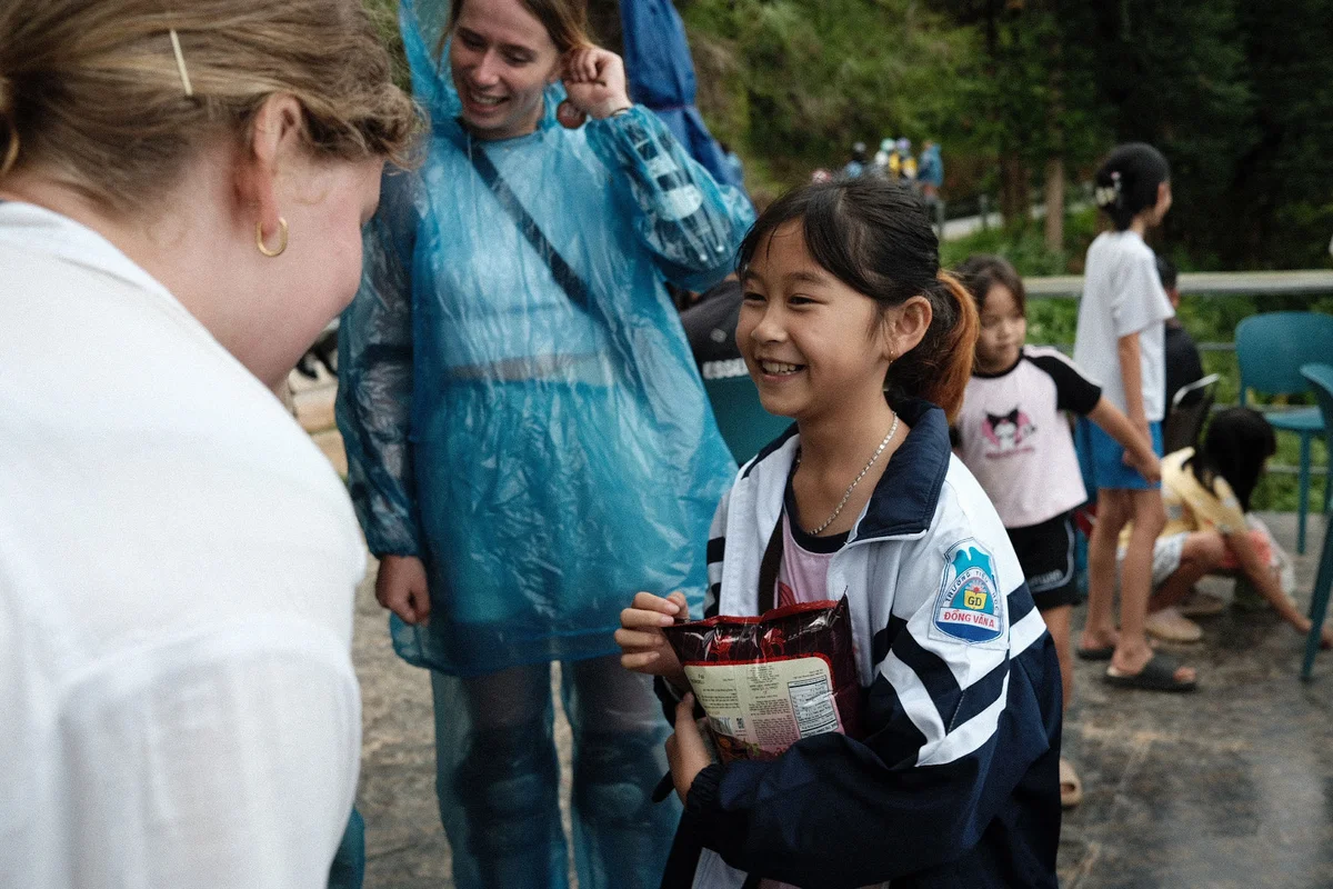 Young child smiles at a tourist on the Ha Giang Loop