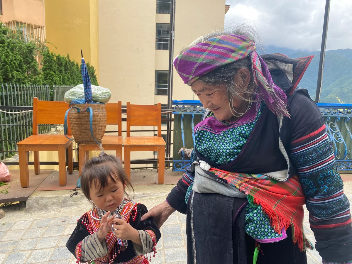 A child with her grandmother holds a snickers 