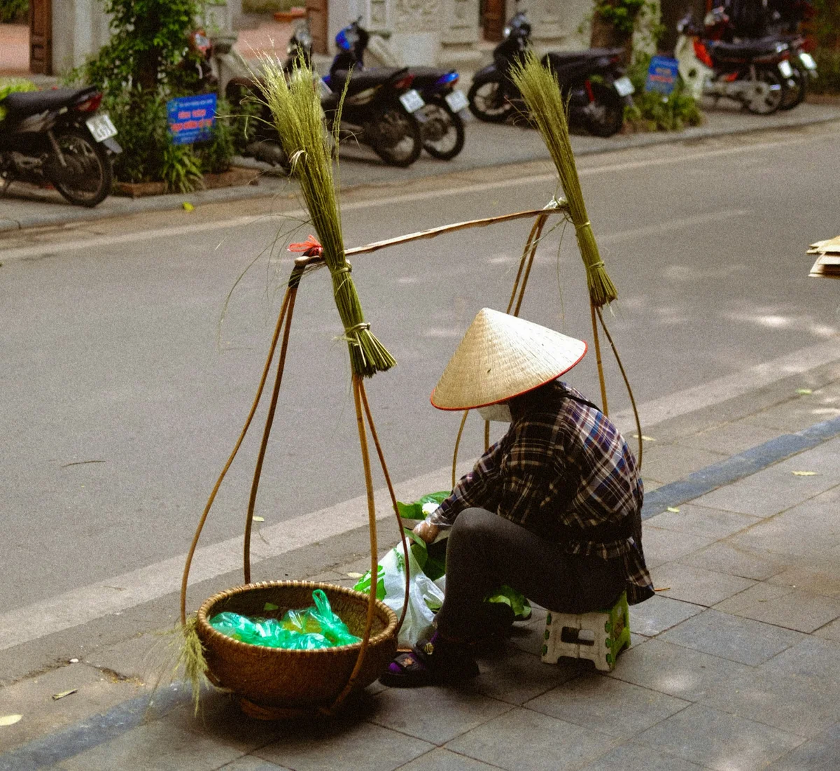 Street vendor resting and preparing food in Vietnam