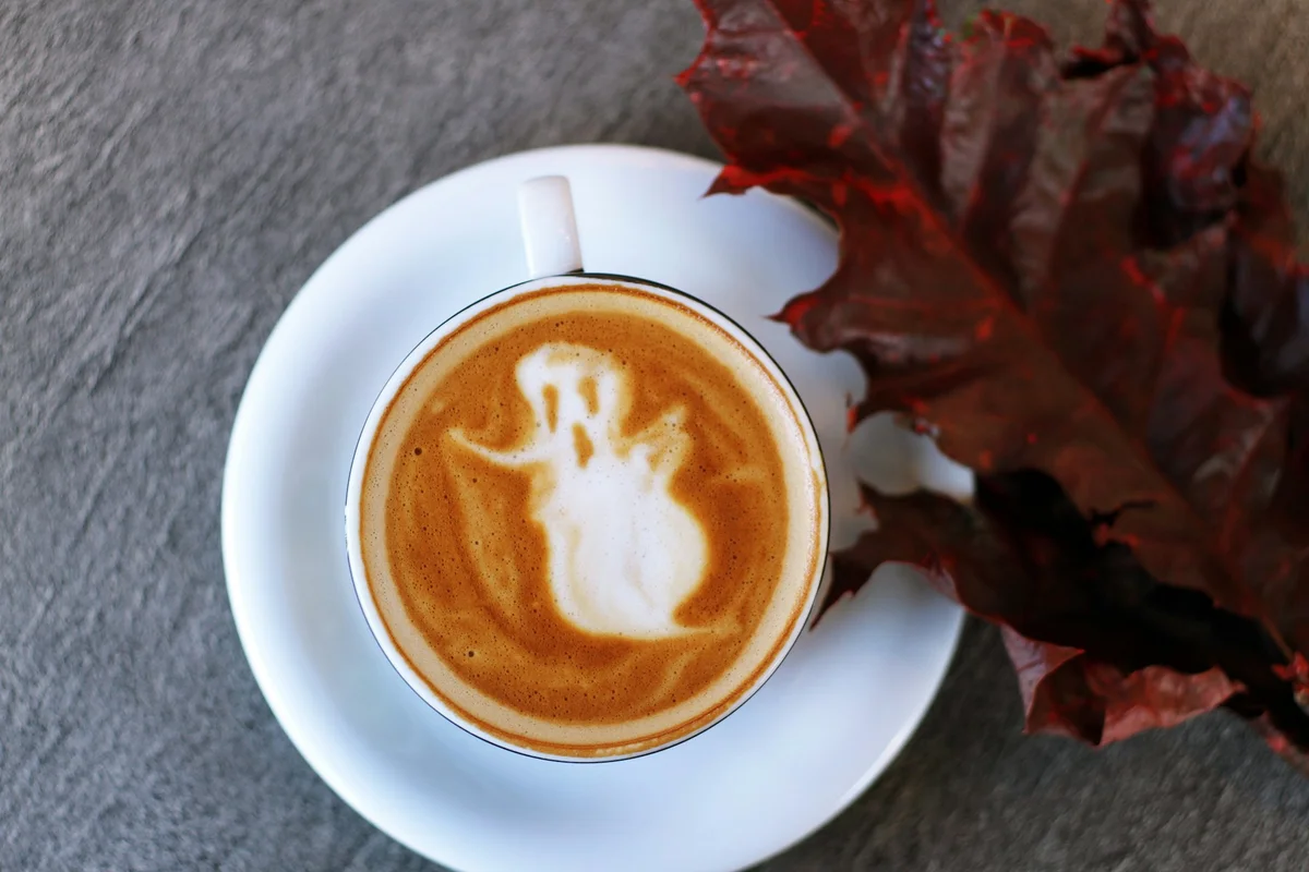 A ghost decoration made with milk foam inside a coffee
