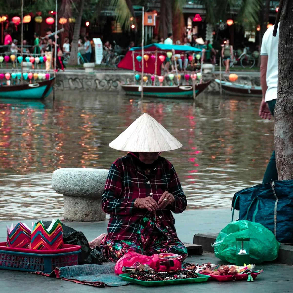 Woman making lanterns by the river in Hoi An, Vietnam
