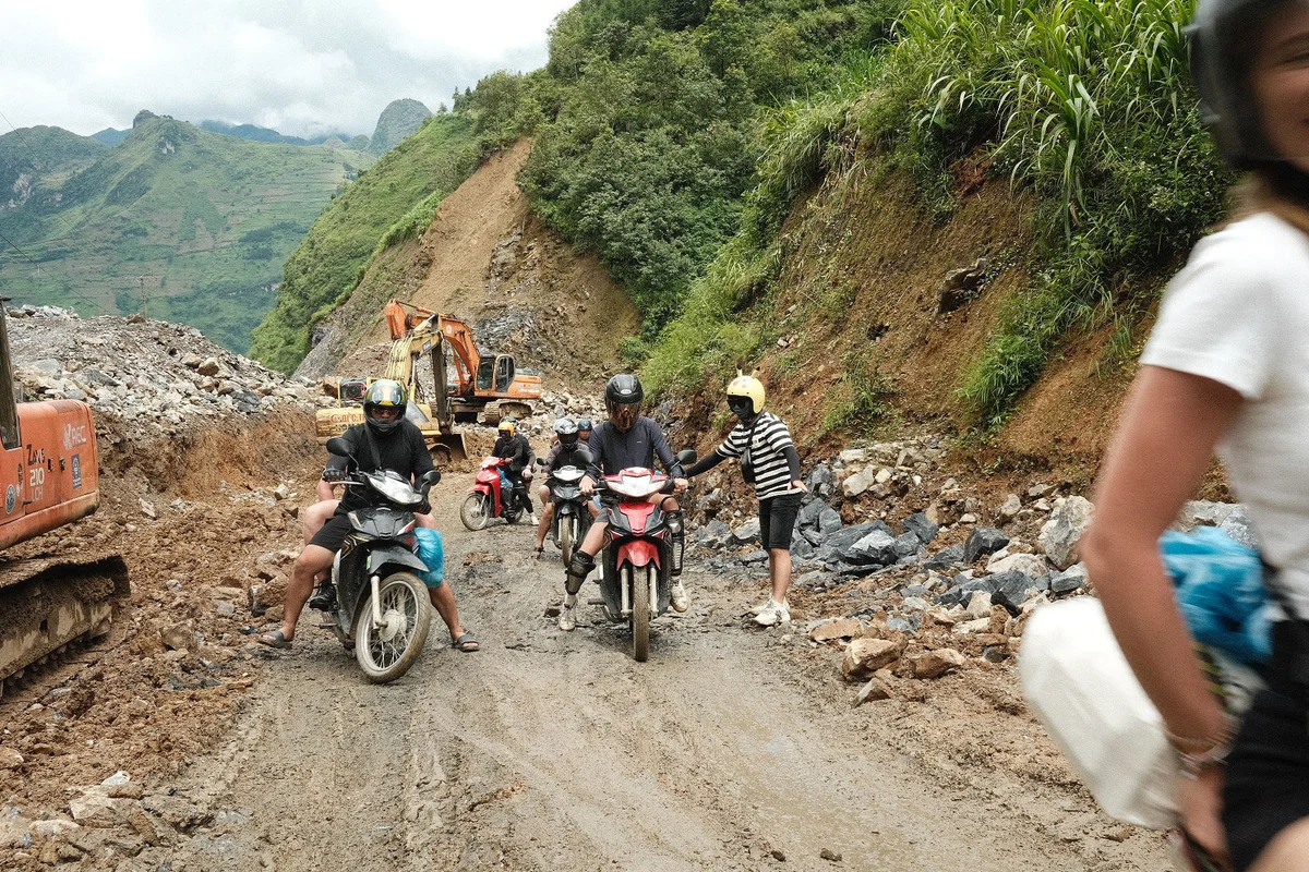 Motorbikers navigating difficult terrain