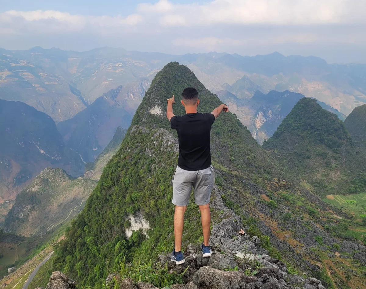 Private tour, man stands on the precipice of a mountain 