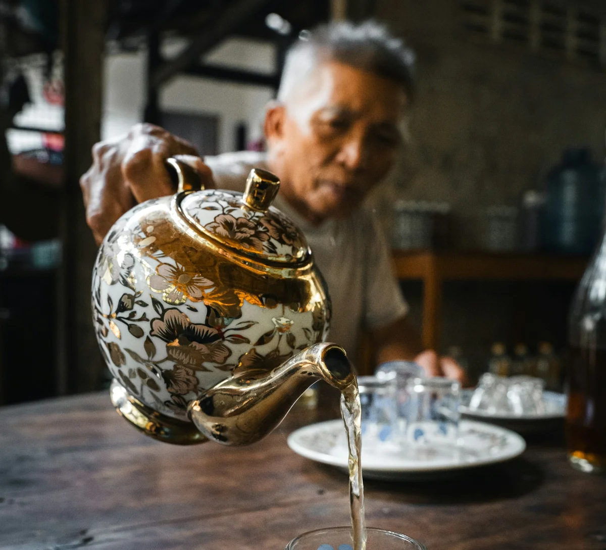 Man pours a cup of tea