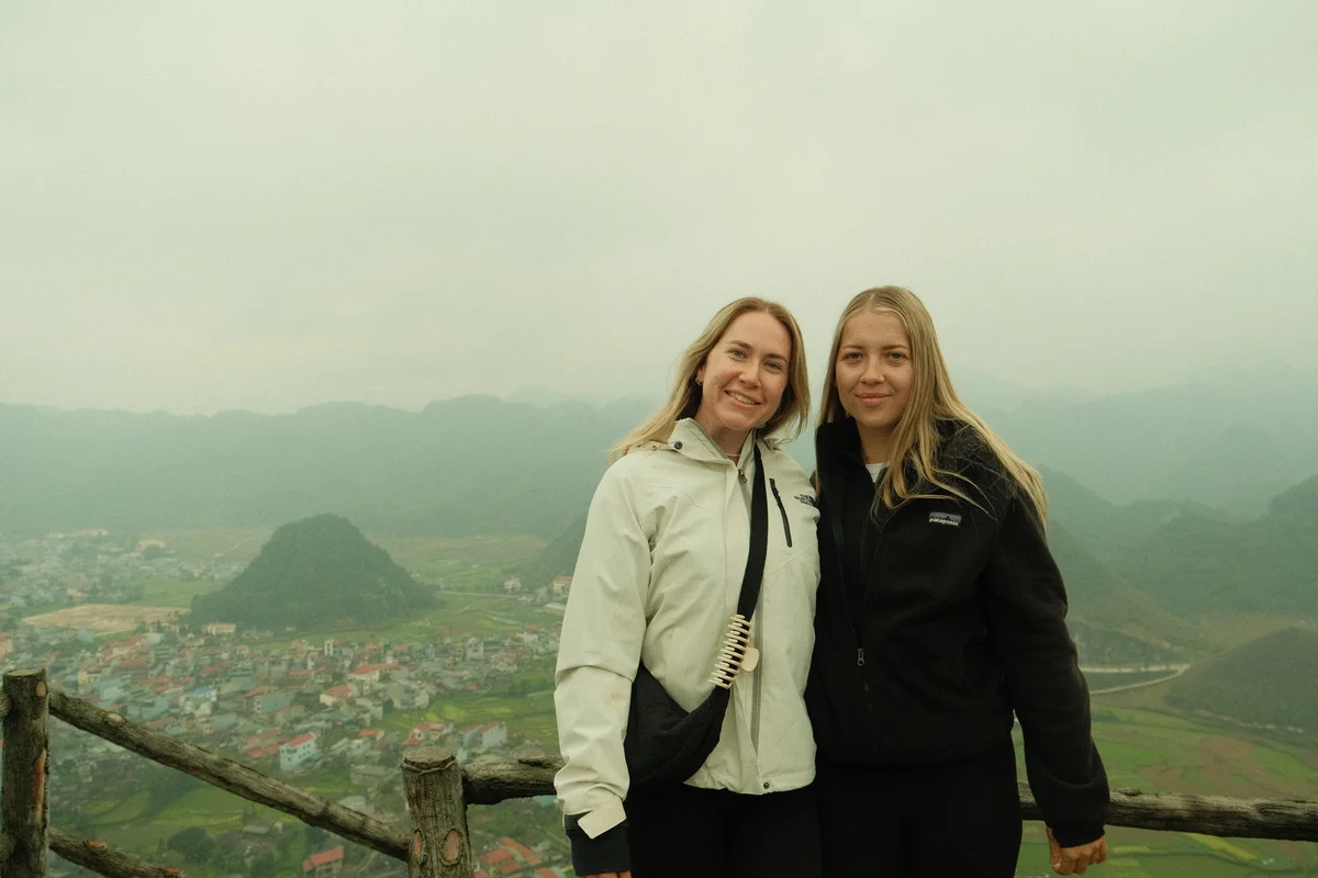 Two guests smile for the camera at Quan Ba twin mountains on the Ha Giang Loop