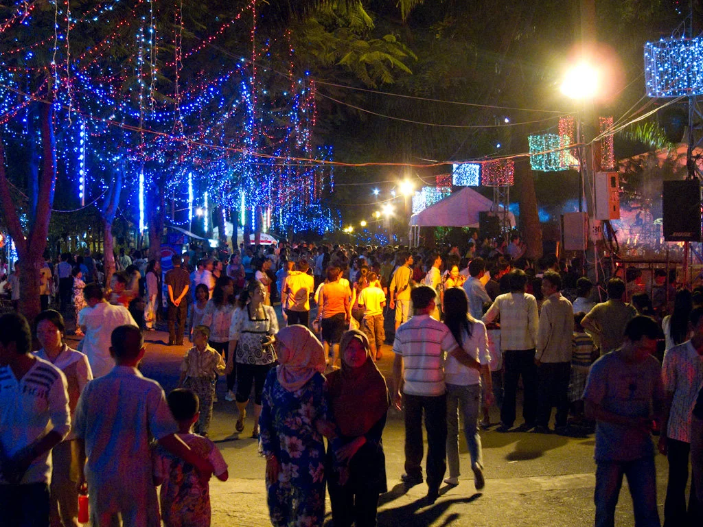 People in the street with lights around