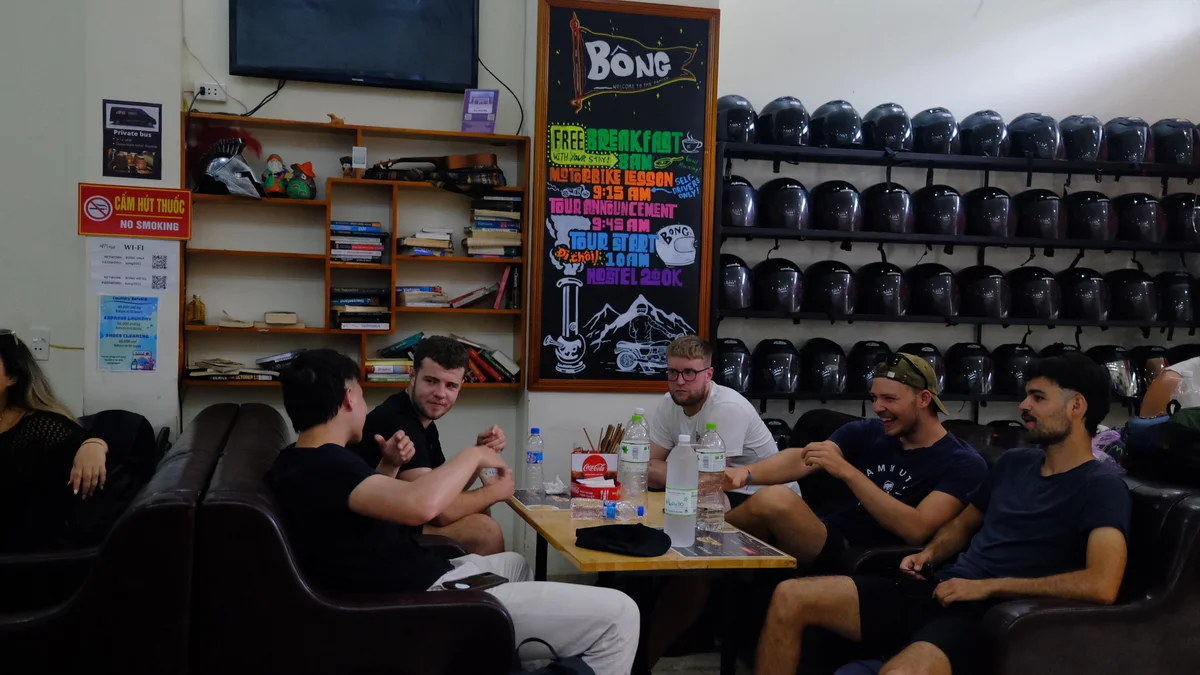 Guests sitting around conversing in Bong Ha Giang Hostel