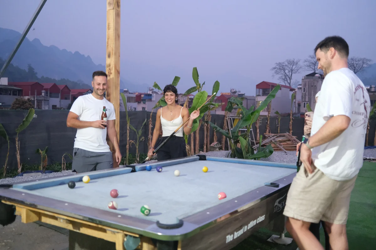 Guests playing pool on the Ha Giang Loop with Bong Hostel
