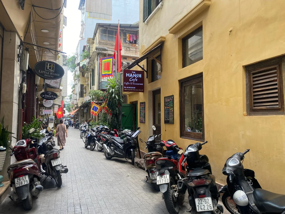 A street lined with motorbikes and a cafe