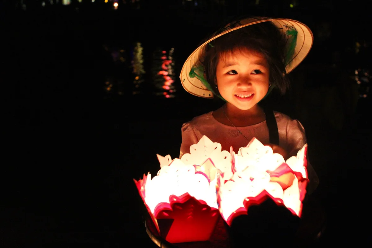 girl holding glowing lanterns