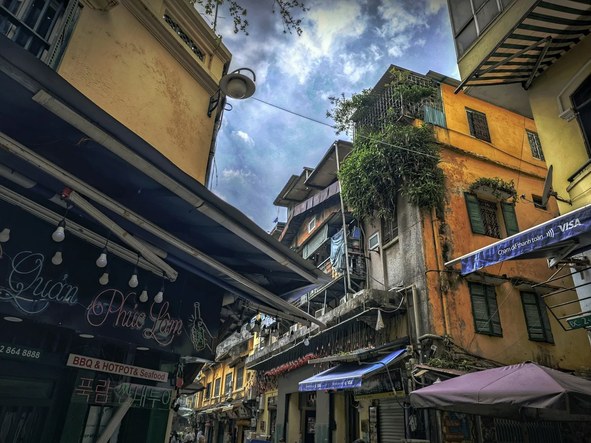 Maze of streets in Hanoi with blue sky and building corners