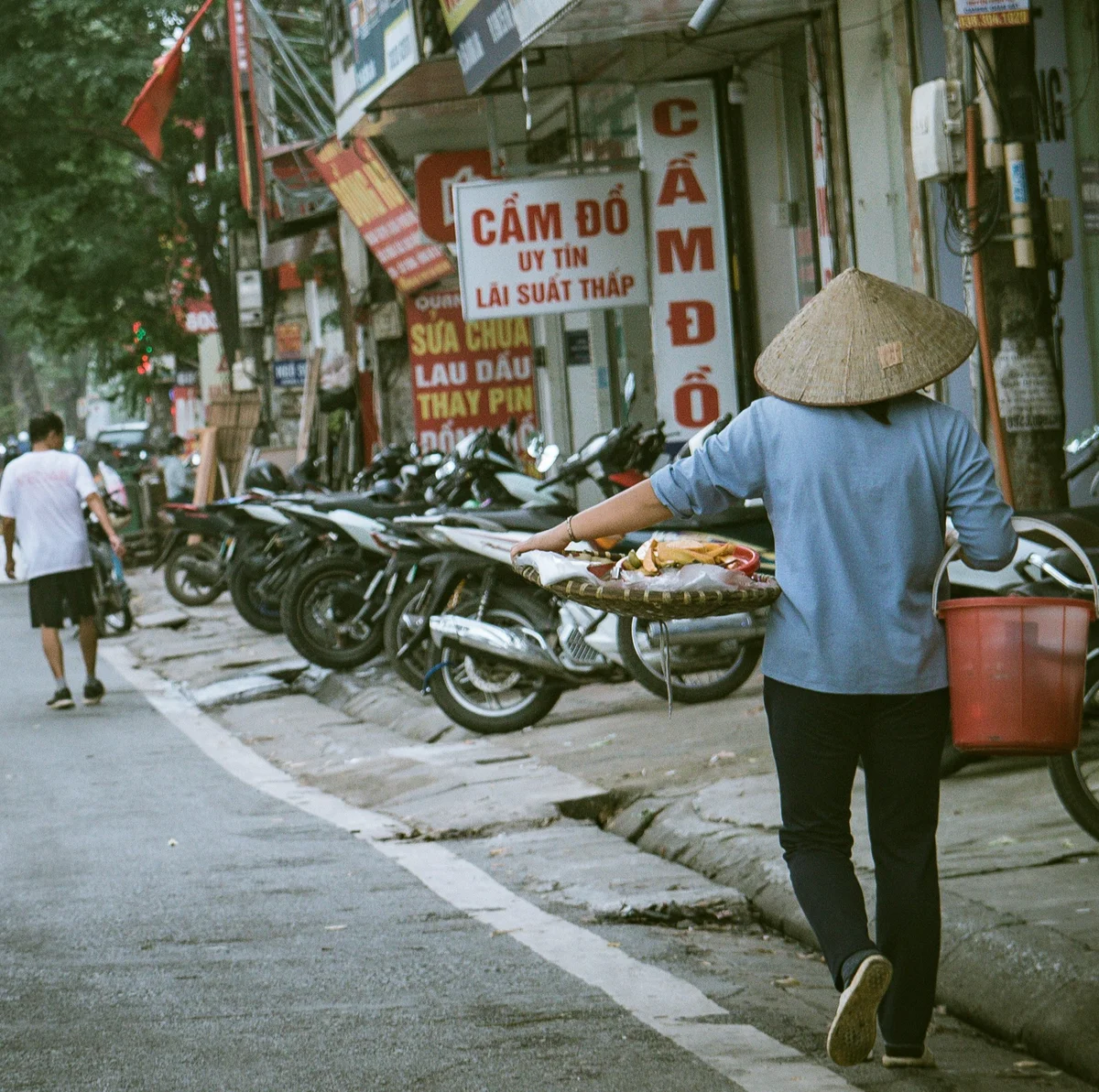 Street vendor carrying produce in Vietnam