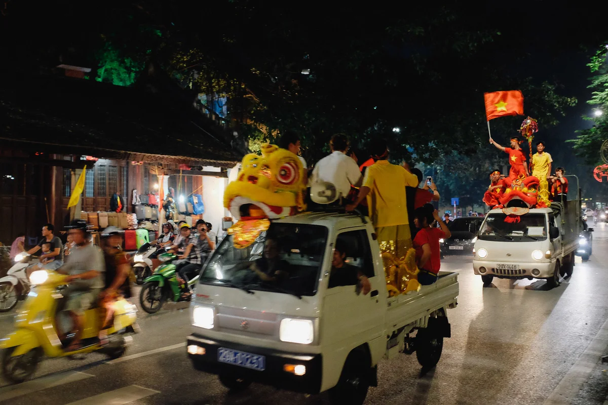 Chaos and lion dancers on the back of trucks in Hanoi