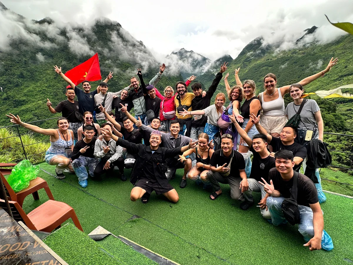 Bong hostel group tour posing at the final viewpoint on the ultimate ha giang loop tour